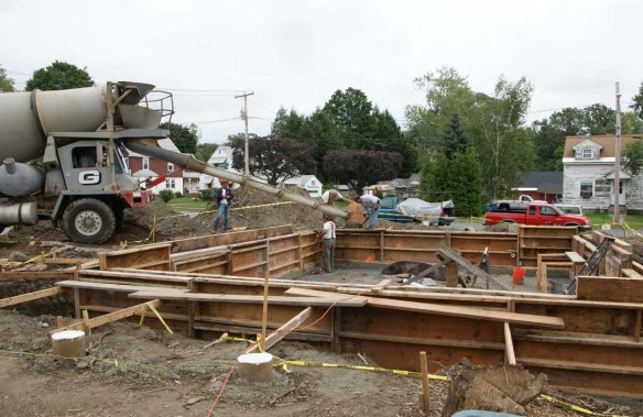 Pouring concrete into house stem wall