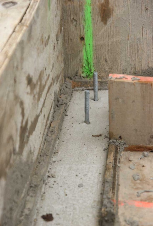 In order to get the height of the stem wall pour accurate we put a continuous strip of wood at the height of the pour and we trowelled to right underneath it. Along with nails (marked by orange spray paint) on the opposite side, it was very easy to get the height of the stem wall right.