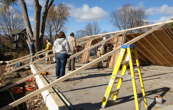 Attaching the push-braces to the north wall with strap hinges