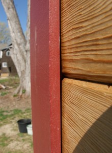 Siding behind trim detail