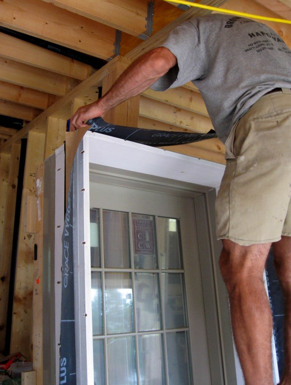 Creating a flange for extension jamb by back-flashing with tape