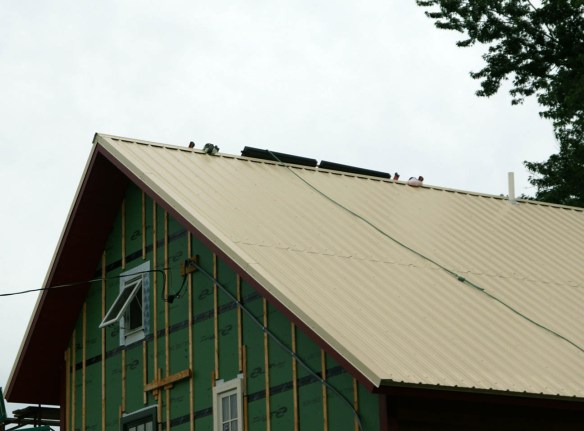 Solar hot water panels peaking over the roof Solar hot water panels peaking over the roof