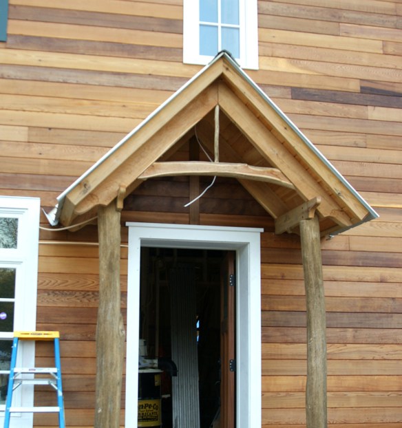 Detail work above entry way mirrors the black locust truss