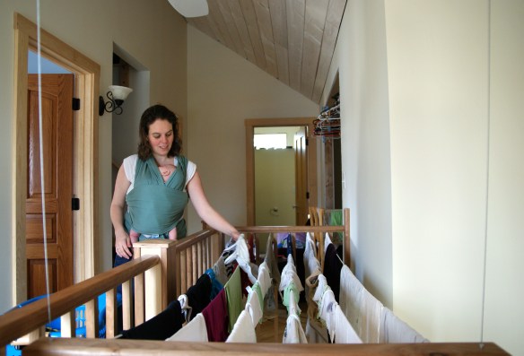 Hannah hanging clothes on indoor clothes line